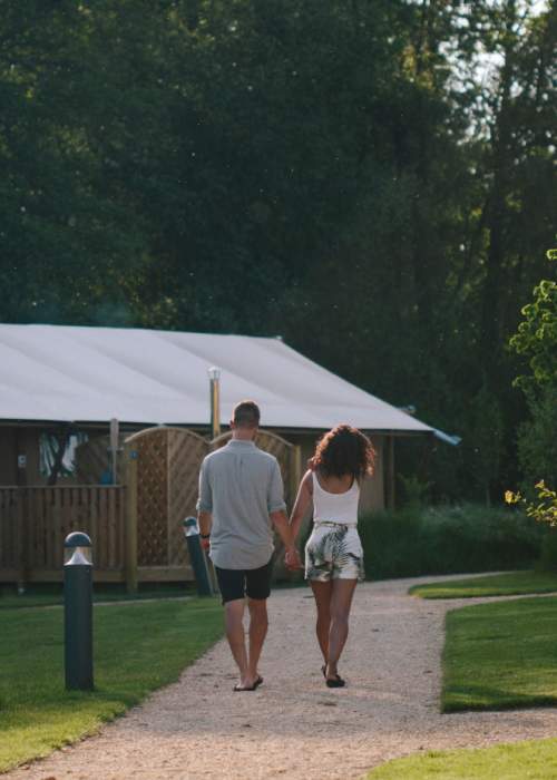 Couple walking through holiday village in the New Forest