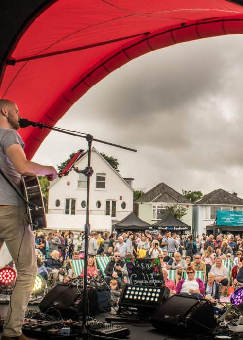 Crowd and live singer at Lymington Seafood Festival in the New Forest
