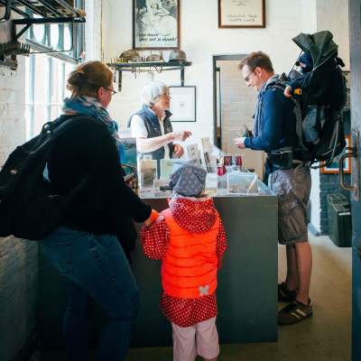 Family buying tickets for Hurst Castle in the New Forest - Attraction Insp