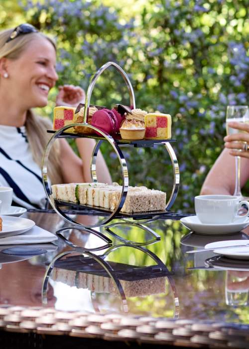 Two ladies enjoying afternoon tea in hotel garden in the New Forest